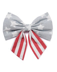 Bow with gray star pattern and red and white striped ribbon on a white background