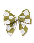 A green and white checkered sailor bow tie with elastic loops for attaching to a collar.