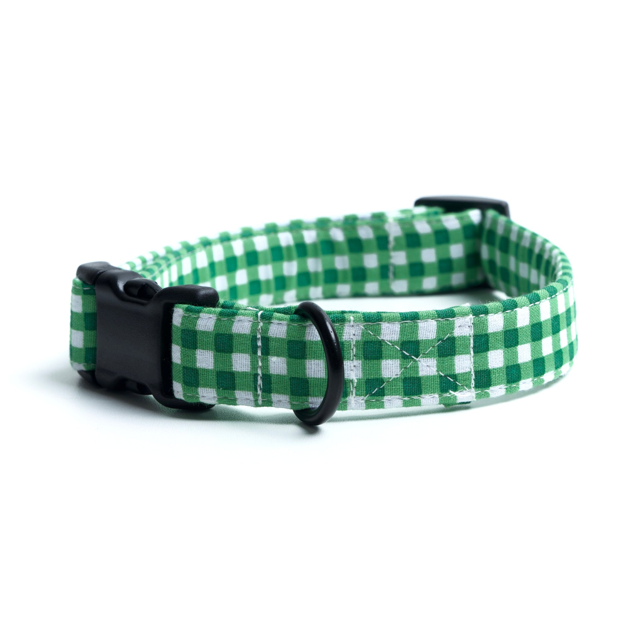 Green and white checkered dog collar with a black buckle on a white background