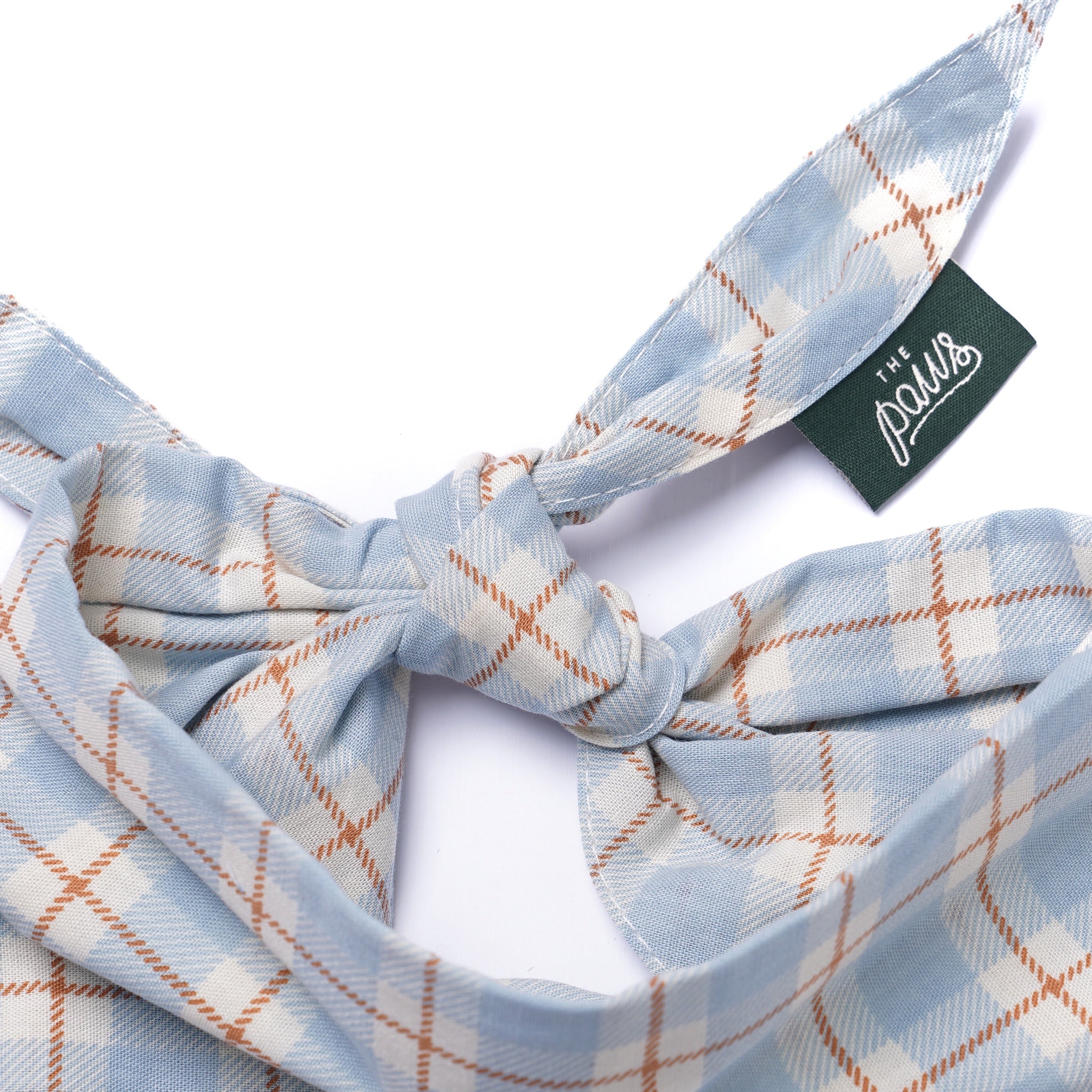 Plaid headband with a The Paws tag on a white background