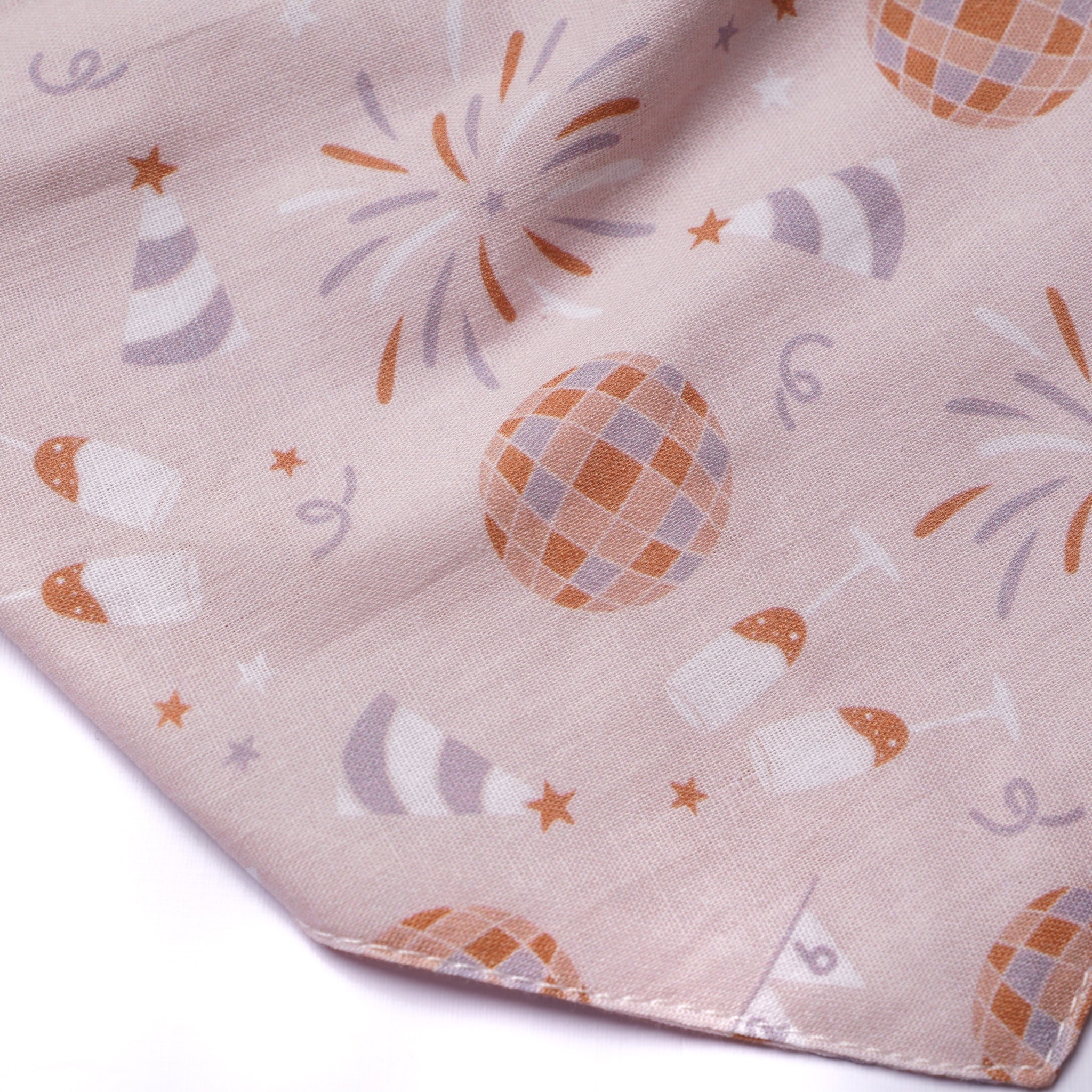 Fabric with festive pattern including balloons, stars, and fireworks on a beige background
