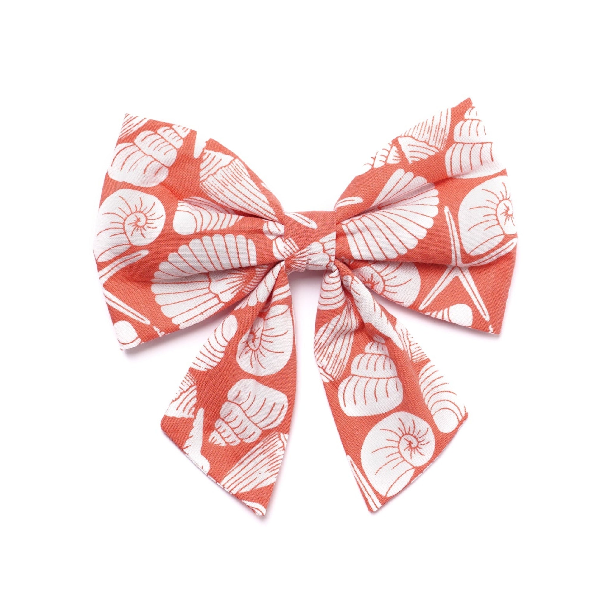 Large bow with coral and white shell pattern on a white background