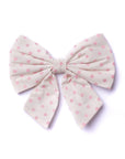 Large fabric bow with pink polka dots on a white background