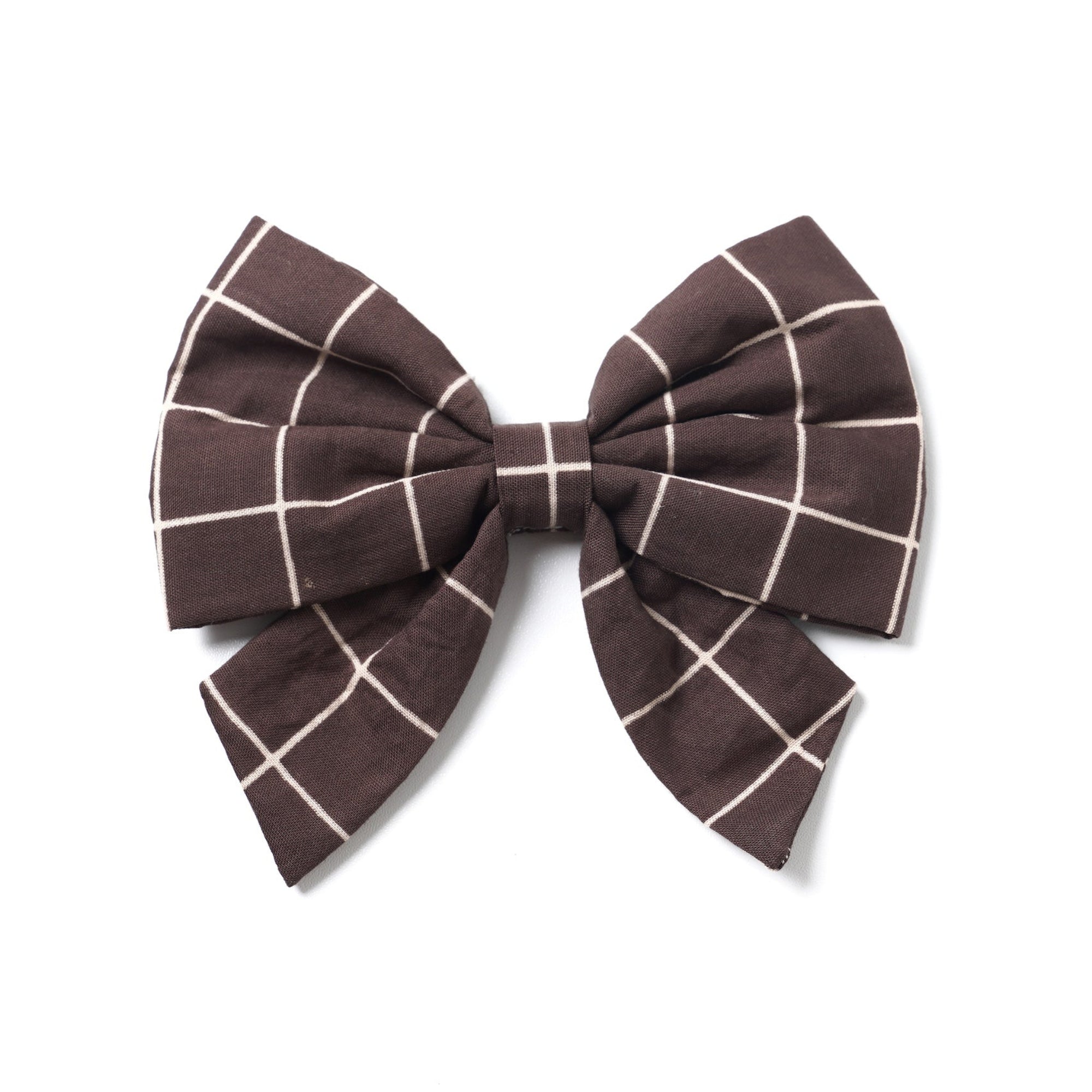 A sailor bow tie with a geometric pattern in black and brown colors, featuring two elastic loops on the back.