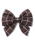 A sailor bow tie with a geometric pattern in black and brown colors, featuring two elastic loops on the back.